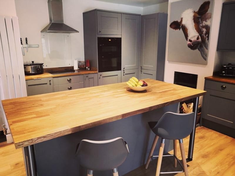 Finished kitchen-diner with grey Shaker-style units and a wooden-topped island