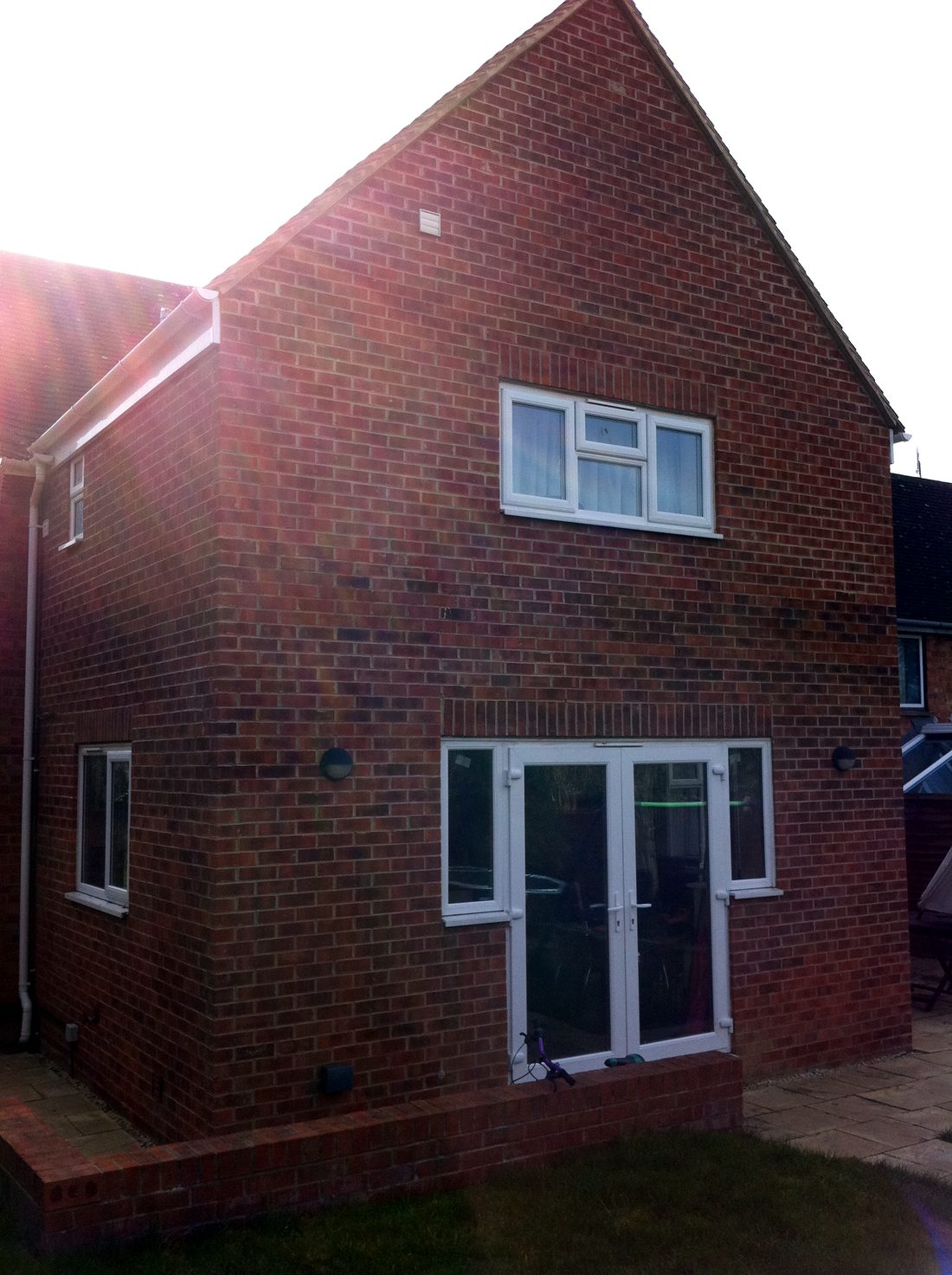 The finished two-storey rear extension with the ground cleared