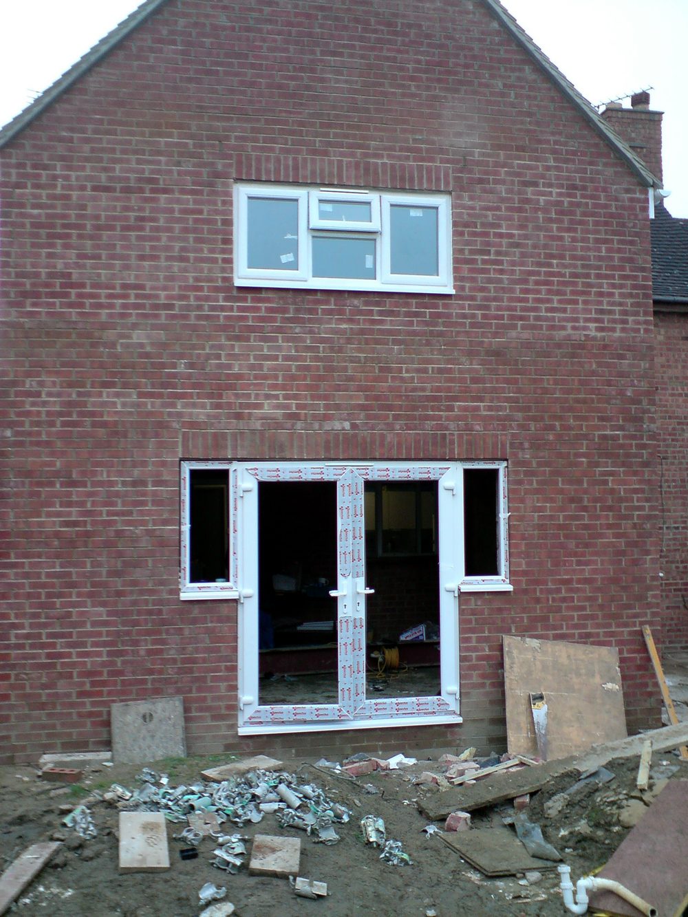 The same extension with the gable built and French doors fitted, scaffold down