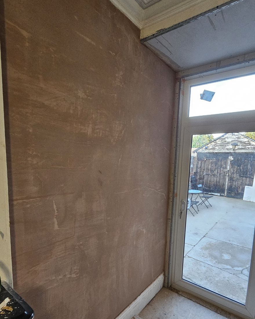 Rear-room walls freshly skimmed around the new white French doors