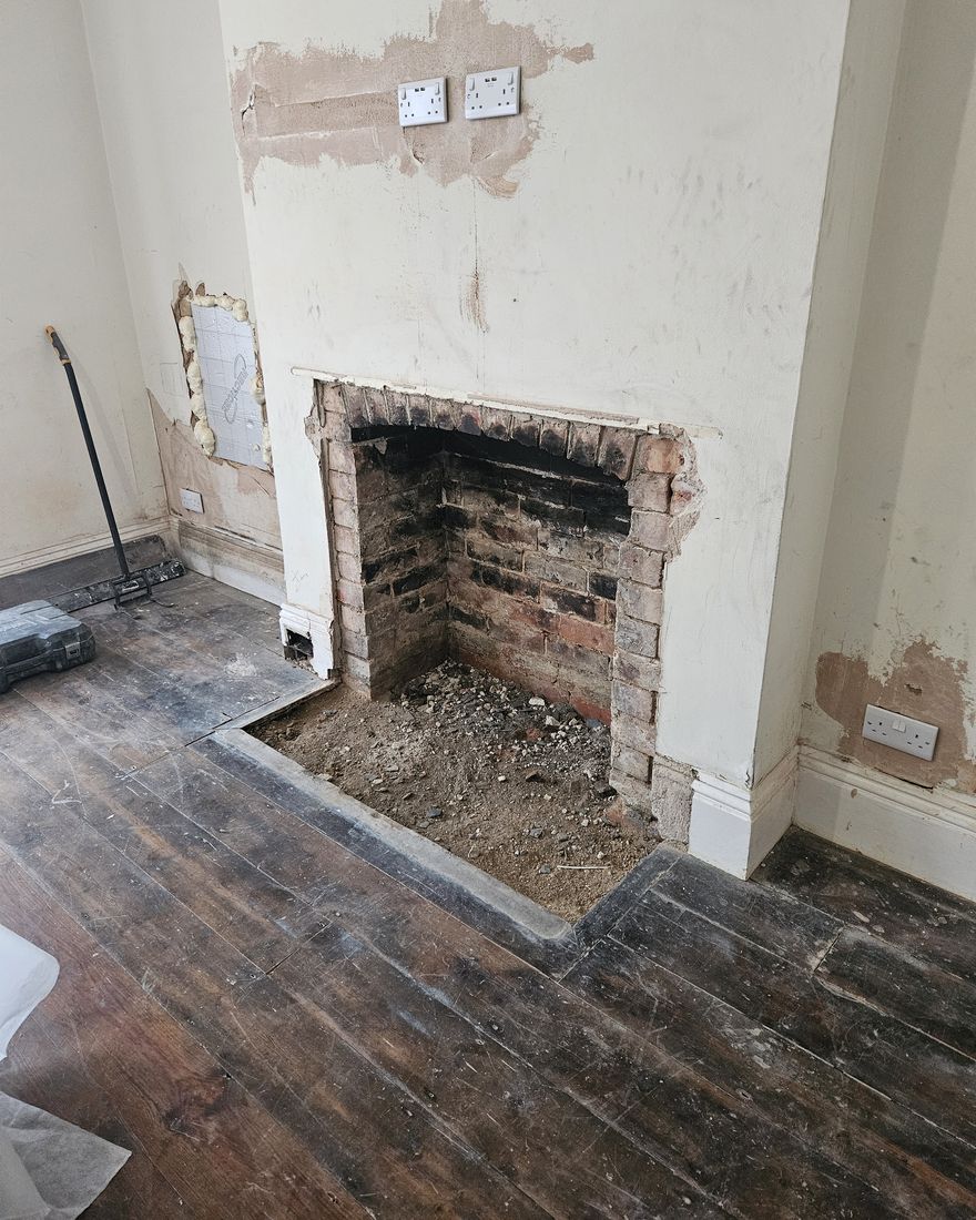 The same fireplace opened back to the brickwork with the surround removed
