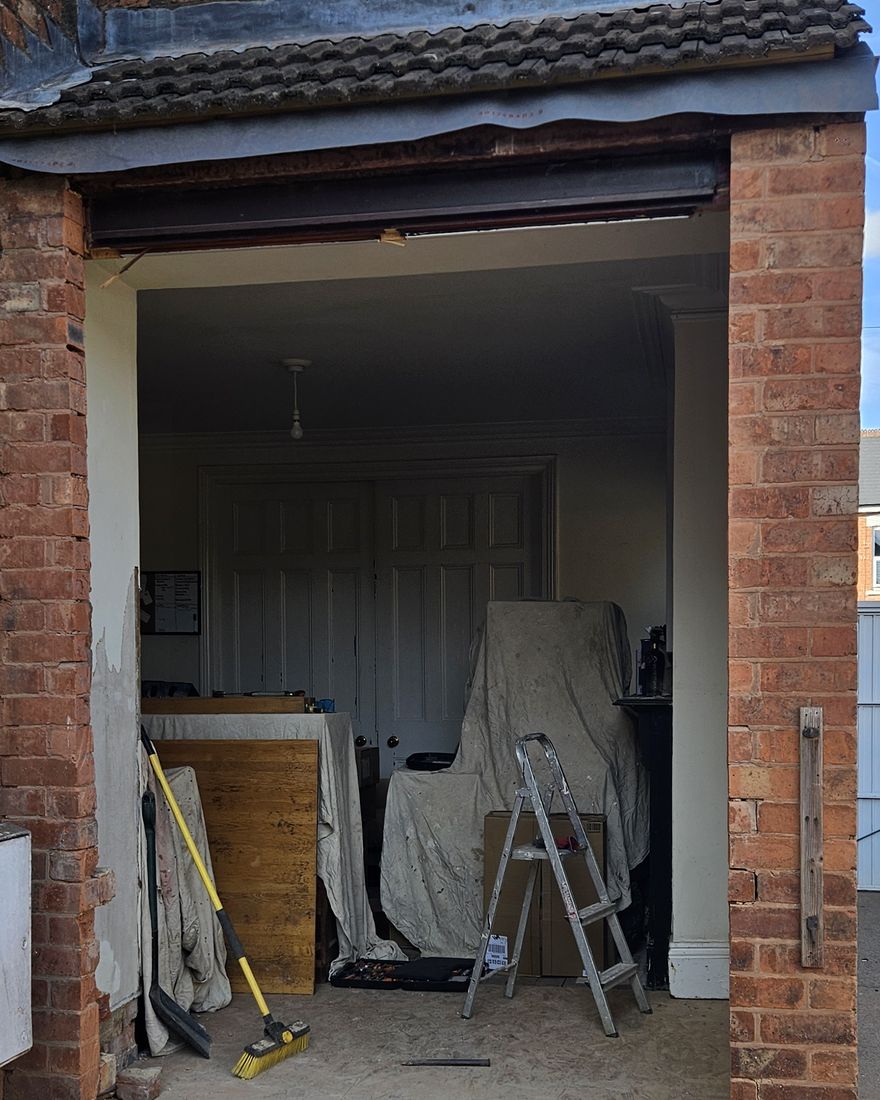 Full-height opening formed in the brick rear wall of a lean-to
