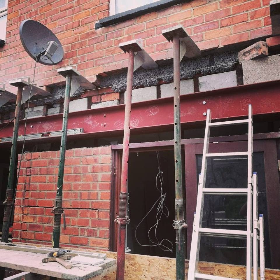 New steel over an opening in a rear brick wall, with the brickwork above supported on props