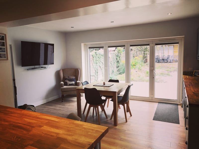 Open-plan kitchen and dining area with bi-fold doors, after the extension in Linden, Gloucester