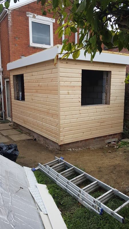 Timber-clad, flat-roofed extension taking shape in St Paul’s, Gloucester, before the windows went in